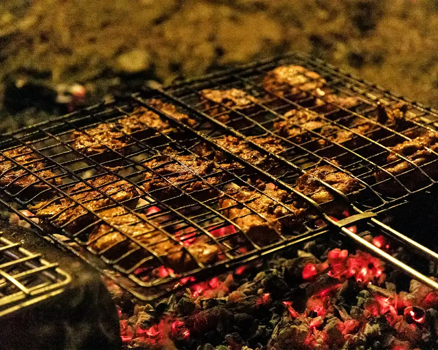 Meat grilling over charcoal at the barbecue