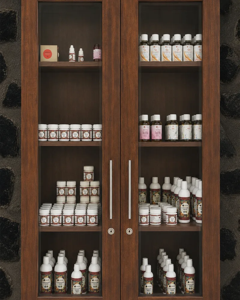 A glass fronted cabinet of medicated oils and preparations, each shelf labelled